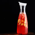 Acrylic water carafe with flip top lid, food-grade, recyclable, shatterproof pitcher for water, iced tea, or juice.