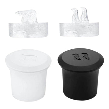Two 3D silicone ice cube trays with polar bear and penguin shapes for whiskey and cold drinks, by Everything Baby.