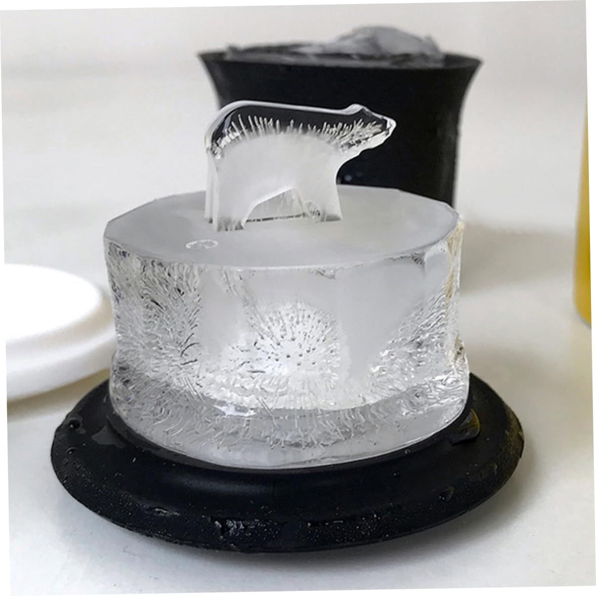 Two 3D silicone ice cube trays by Everything Baby shaping polar bears and penguins for fun pretend play and beverage use.