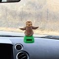 Solar dancing figure toy from Everything Baby, a shaking hand doll for car dashboard, desk, or windowsill decoration