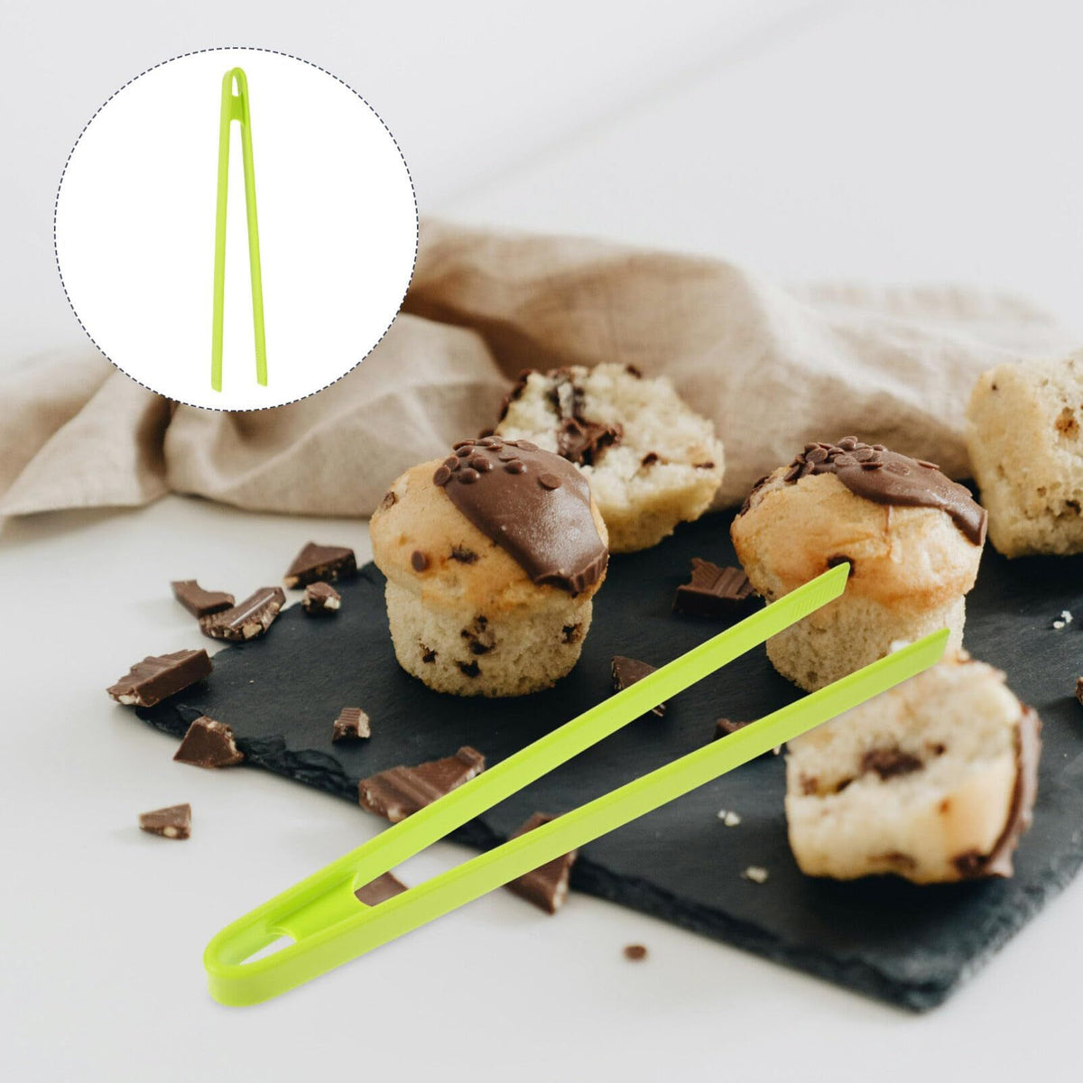 Silicone food clip by Everything Baby, used for sushi, barbecue, and kitchen tasks, shown holding food in a kitchen setting.