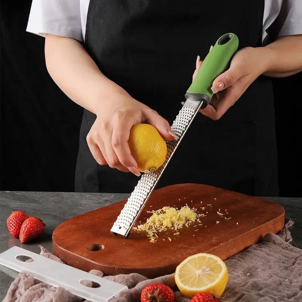 Stainless steel lemon cheese grater by Everything Baby, ideal for zesting lemons, cheese, garlic, and other produce in the kitchen.