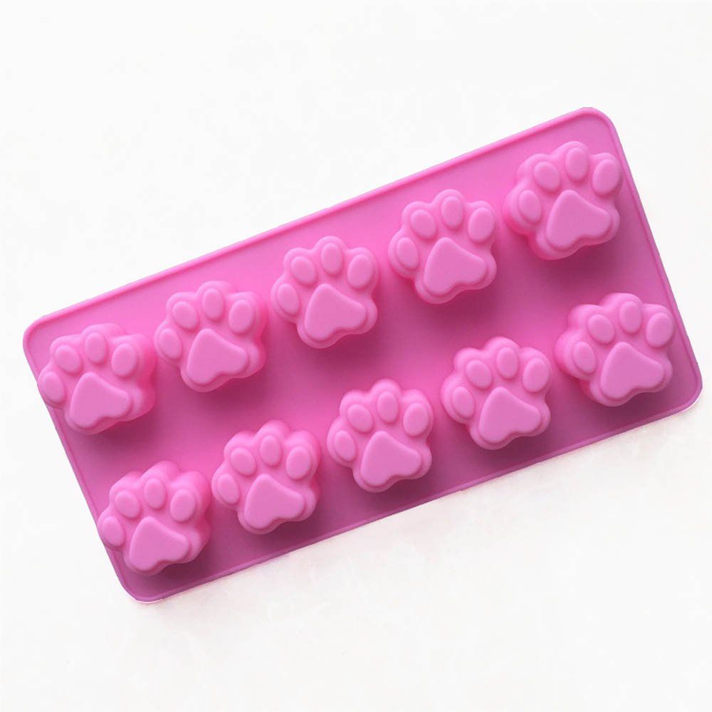 Pink silicone mold with mini dog and cat paw prints for cupcakes, ice cubes, chocolate, soap, or candles, ideal for baking and crafts.