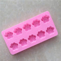 Pink silicone ice tray with mini dog and cat paw prints, suitable for cupcakes, muffins, chocolates, soap, or candles.