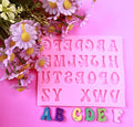Silicone alphabet and number molds for cake decorating, featuring 3D letter and number shapes for baking and fondant.