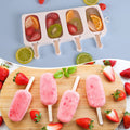 White silicone popsicle molds set with 50 wooden sticks, ideal for making ice pops, cakesicles, and cake pops for kids.