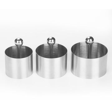 Stainless steel sushi making molds with pushers, round pastry rings, and tuna mold for food presentation, suitable for kitchen use.