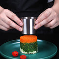 Stainless steel sushi making molds with pushers, round pastry rings, and tuna mold for food presentation in a pretend play kitchen.