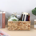 Handwoven water hyacinth storage basket with handles, small decorative wicker bin for organization and outdoor play use.