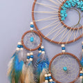 Blue and brown feather dream catchers for kids' bedroom, small wall hanging decor from Everything Baby, ideal for pretend play rooms.