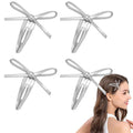 Four silver leather bow hair clips for girls, snap hair clips featuring stylish bowknot design for kids bangs and hair accessories.