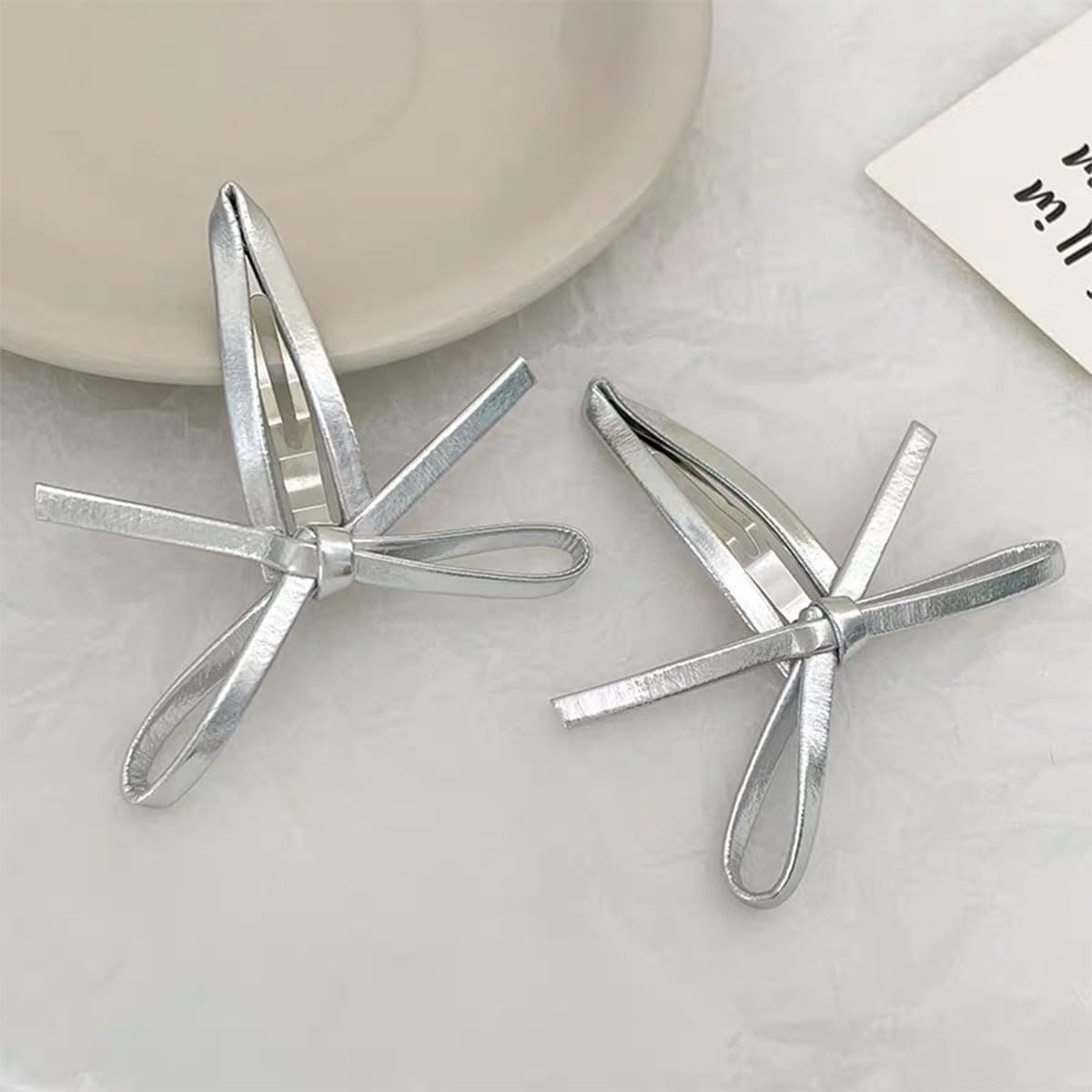 Set of 4 silver leather bow hair clips for girls, featuring snap closure and cute bowknot design, ideal for kids' bangs and hair styling.