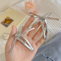 Four silver leather bow hair clips for girls, featuring snap closure and cute bowknot design, perfect for kids' bangs and hair styling.