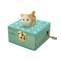 Mini wooden hand crank music box with a cute cat design, wrapped as a gift, playing 