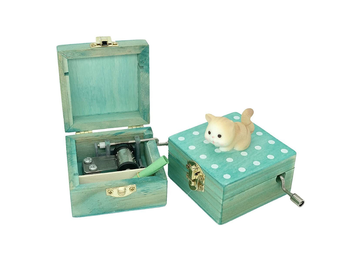 Mini wooden hand crank music box with a cute cat design, playing "Castle in the Sky," wrapped as a gift, in brownish yellow.