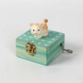 Gift wrapped mini wooden music box with a cat design, hand crank, playing 