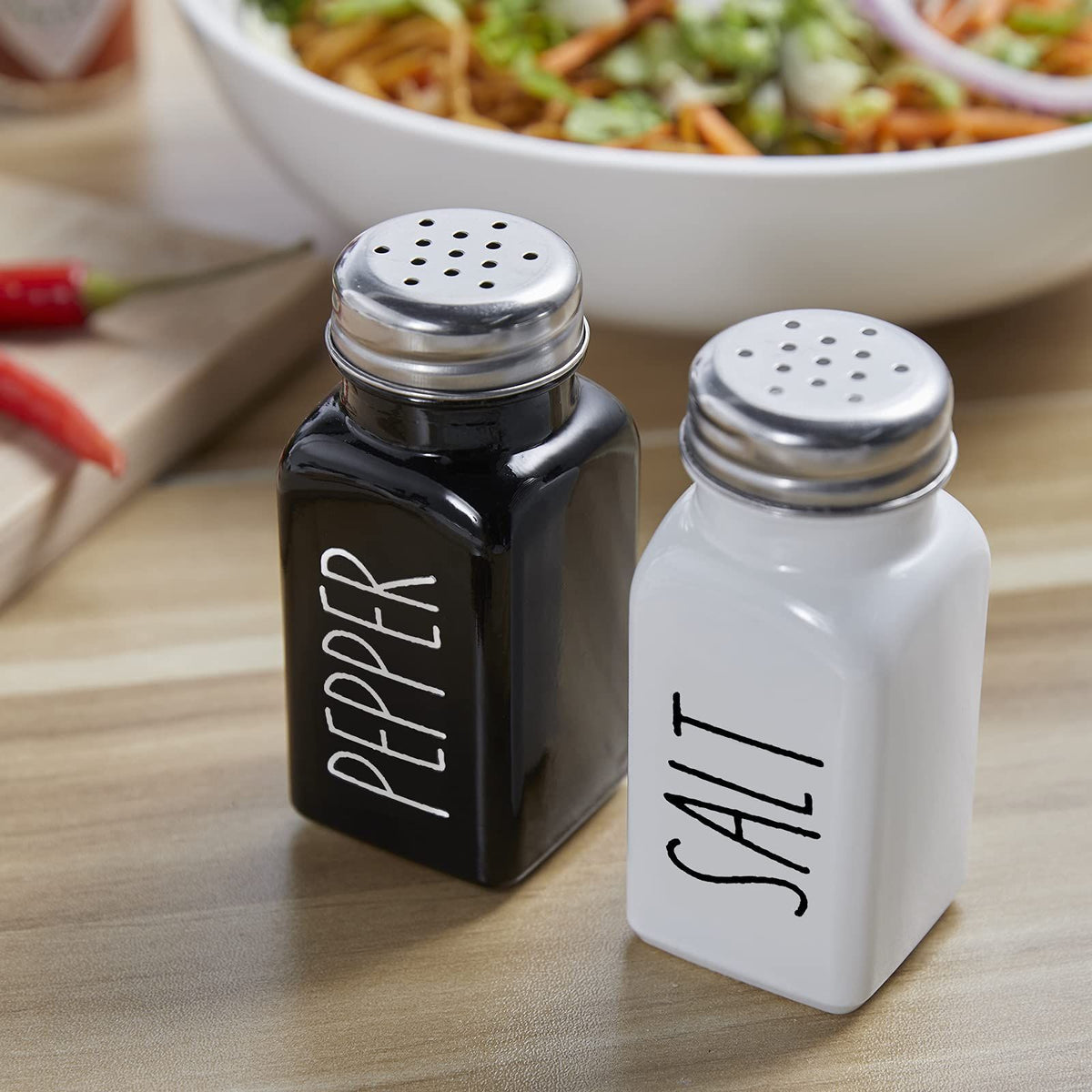 Cute glass salt and pepper shakers set with stainless steel lids, farmhouse style for kitchen table decor, ideal for kids' pretend play.