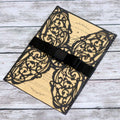 Laser cut Halloween invitation cards in black with hollow designs, part of the 2-piece party invitation set by Everything Baby.