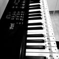 Transparent piano keyboard stickers by Everything Baby on a child's toy piano, easy to remove and perfect for kids learning piano.