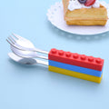 Set of three toddler utensils with interlocking brick design, including fork, spoon, and knife for kids' mealtime.