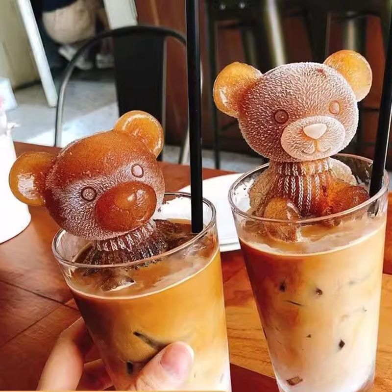Two 3D teddy bear silicone ice cube molds for making animal-shaped ice cubes, soap, or candies, ideal for drinks and desserts.