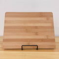 Metal square wire stand for cutting boards, cheese platters, or cookbooks, ideal for organizing kitchen or serving displays.