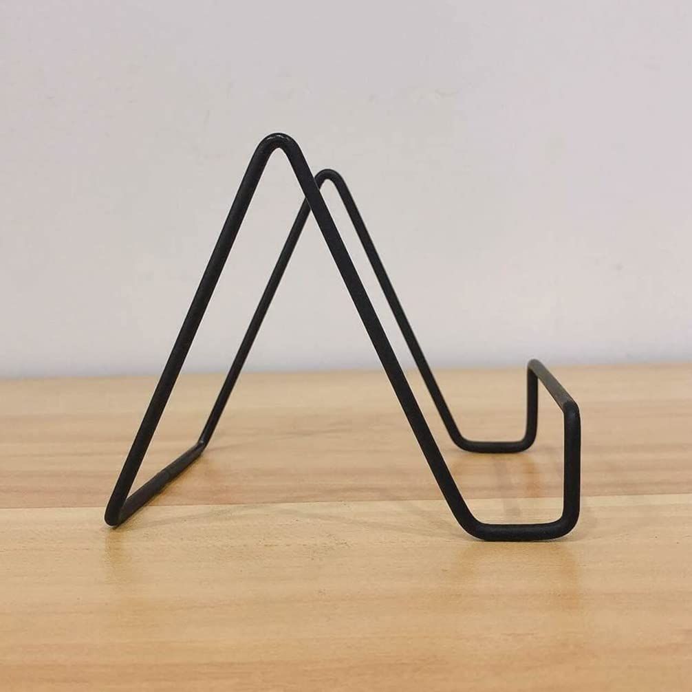 Metal square wire stand for cutting boards, cheese platters, or cookbooks, with a sturdy holder design for kitchen or serving use.
