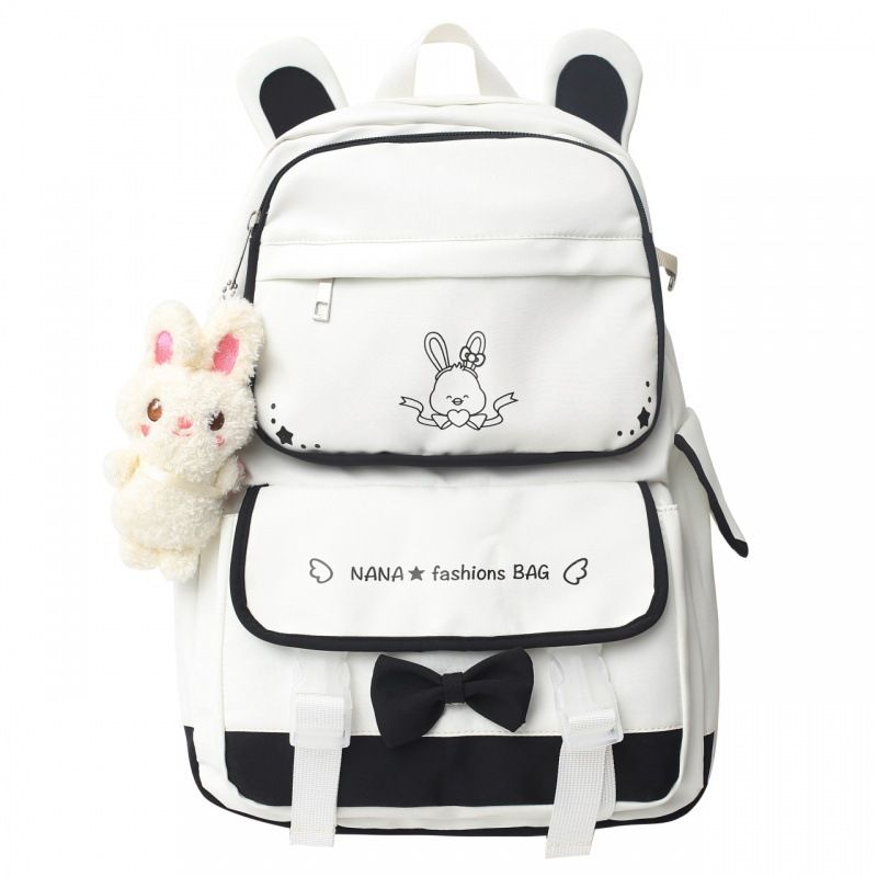 Black kawaii girl backpack with plush doll pendant, cute aesthetic schoolbag for teen girls, featuring colorful straps and playful design.