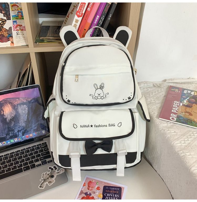 Black Kawaii Girl backpack with plush doll pendant, cute aesthetic schoolbag for teen girls, from Everything Baby.