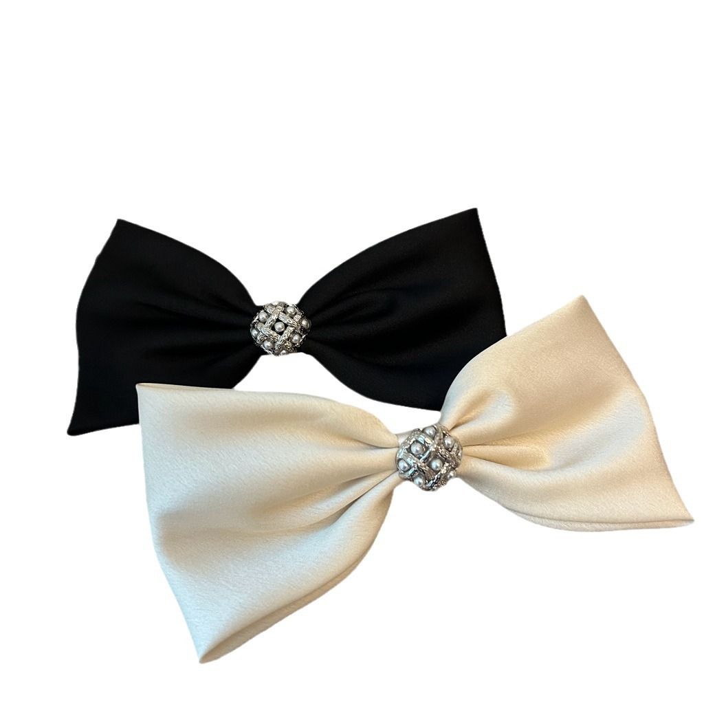 Three decorative French hair barrettes with pearl and rhinestone accents, styled with spring-inspired hair bow clips for women and girls
