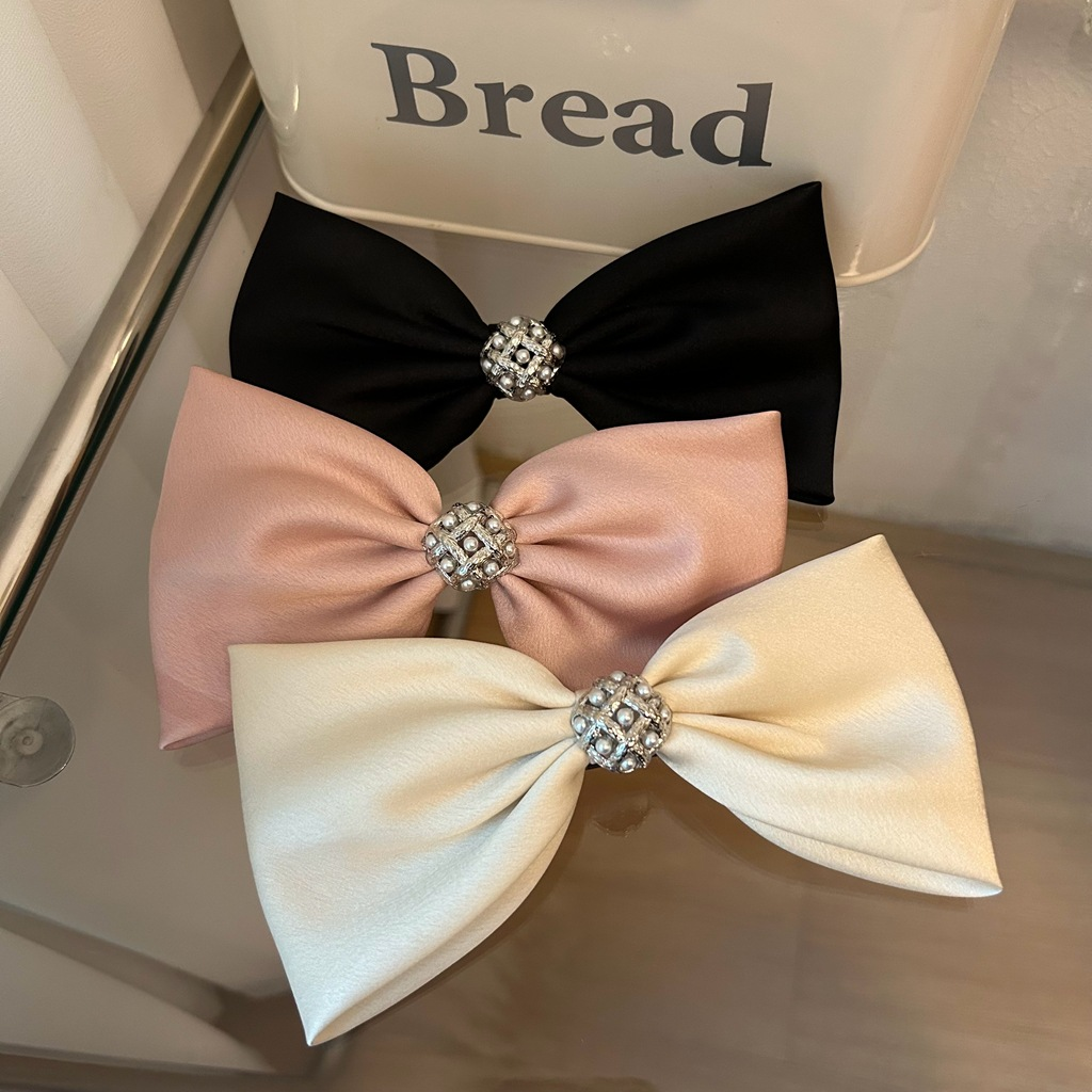 Three decorative French hair barrettes with pearl rhinestones and bow designs, perfect for girls and teens.