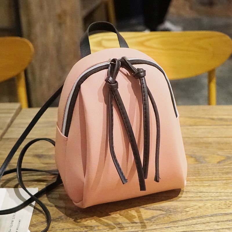 Pink vegan leather mini backpack for women, stylish convertible shoulder bag, perfect for casual outings and travel.