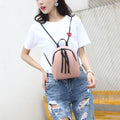 Cute pink vegan leather mini backpack for women, convertible shoulder bag with stylish design, perfect for casual and outdoor use.