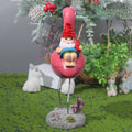 Outdoor garden gnome statue of a gnome riding a flamingo, made of resin, perfect for lawn or patio decor.