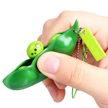 Green Squeeze-a-Bean soybean stress relief toy set with playful charms, perfect for kids' pretend play keys and mobile phone accessories.