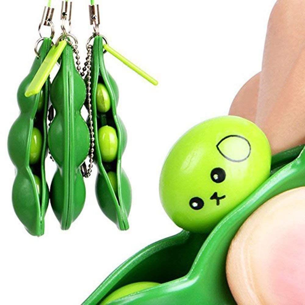 Green squeeze-a-bean soybean stress relief toy set with playful charms, ideal for keys and mobile phones, from Everything Baby.