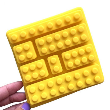 Silicone candy mold with building block shapes for making cute ice cubes, chocolates, and candies, ideal for kids' treats.