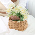 Wicker picnic basket with handle by Everything Baby, perfect for outdoor picnics, garden decor, or as a charming flower girl basket.