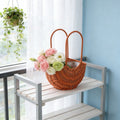 Rattan flower girl basket with handle, half moon shape, straw wicker design, ideal for weddings, picnics, and garden decor.