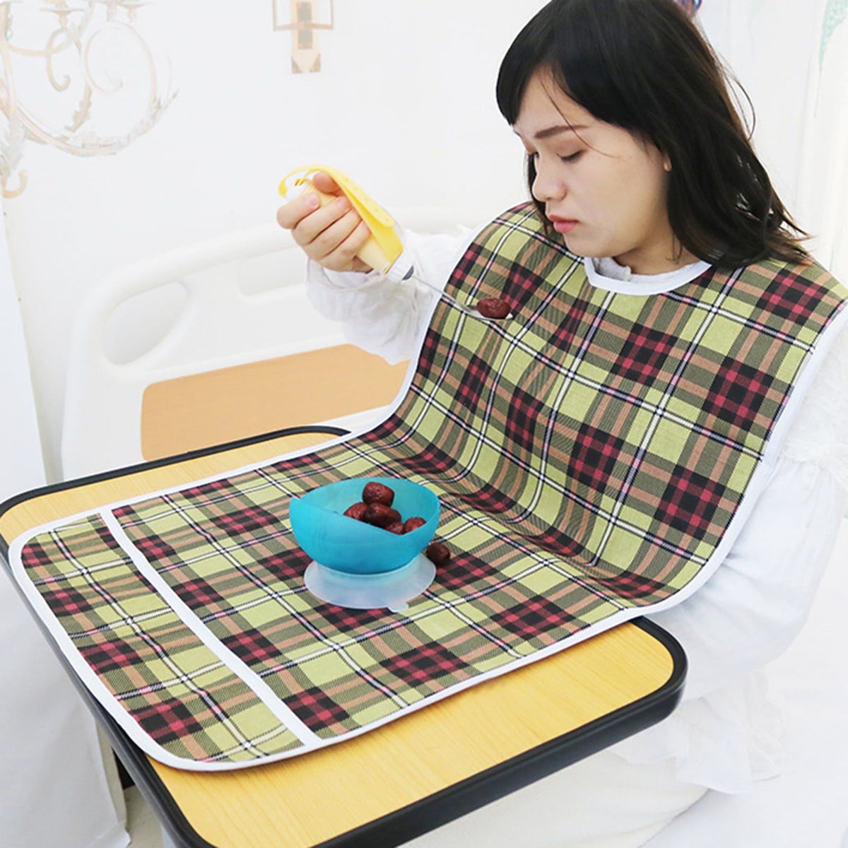 Reusable waterproof adult bib with crumb catcher, ideal for eating, designed for women and men, from Everything Baby.