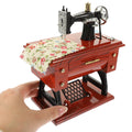 Vintage sewing machine music box toy by Everything Baby, a charming musical toy for kids and sewing enthusiasts.