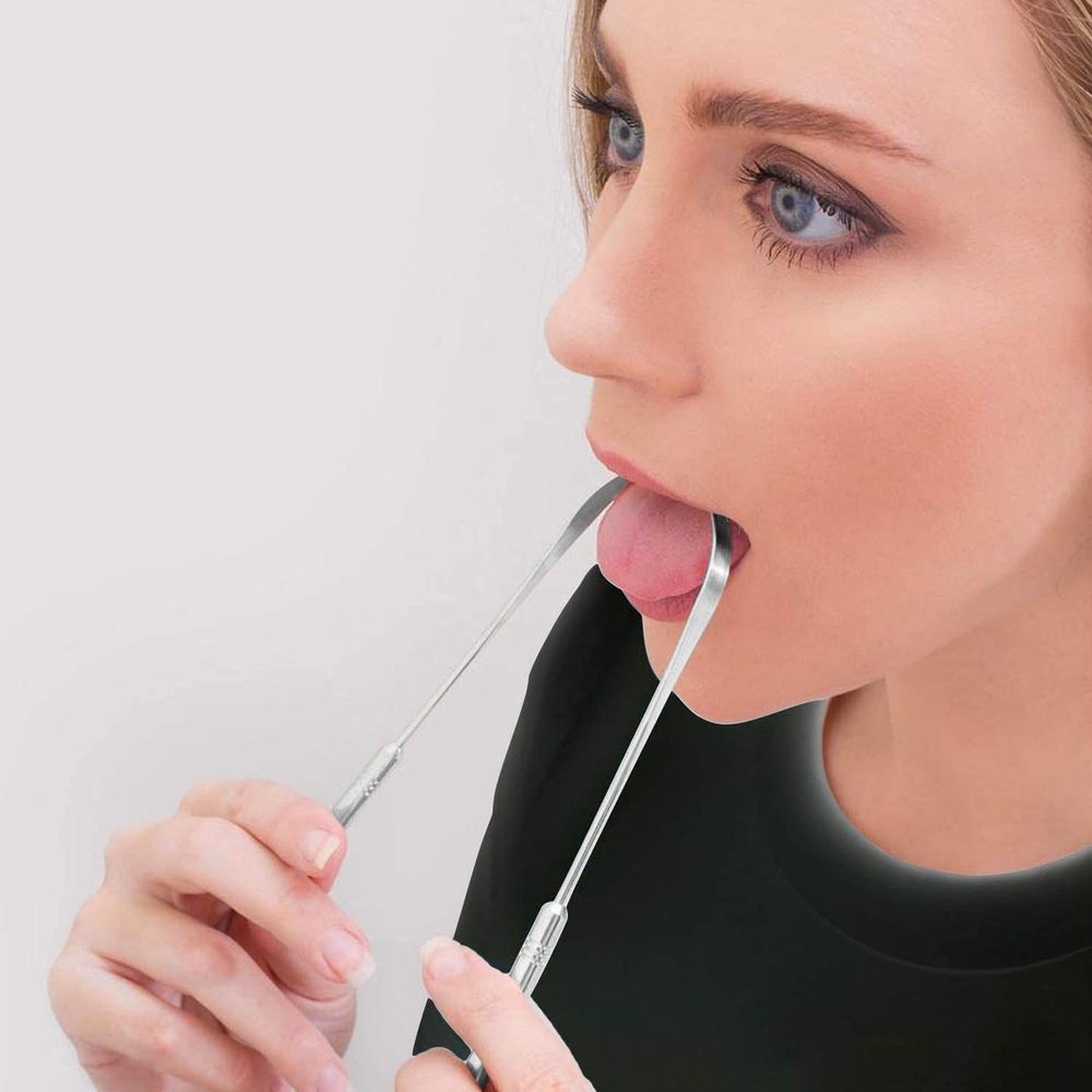 Two stainless steel tongue cleaners with ergonomic handles designed for effective halitosis removal in a baby and kids grooming set.