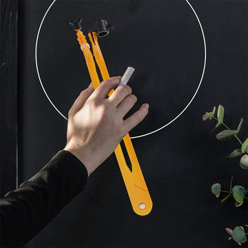 Two large plastic teaching compasses for classroom circle drawing, ideal for educational outdoor play and demonstrations.