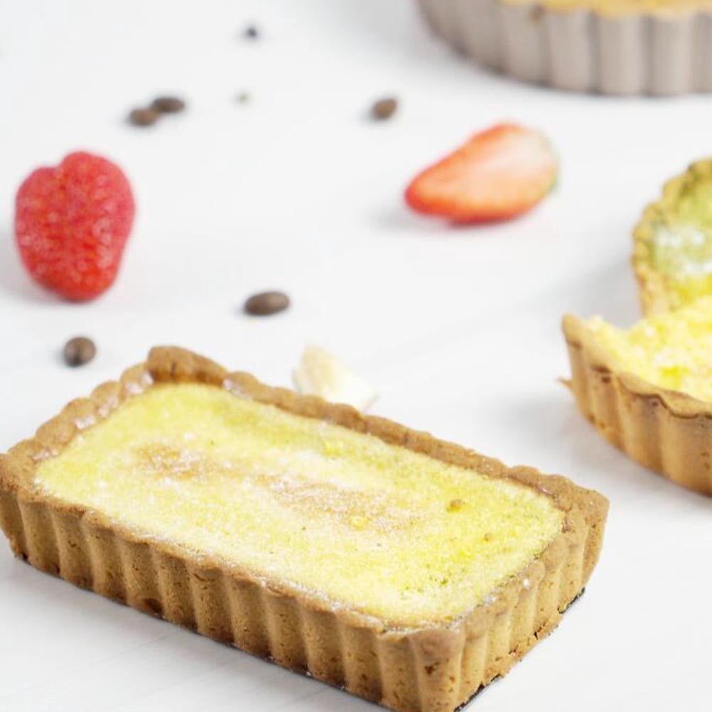 Two black carbon steel baking pans with non-stick coating, ideal for pretend play baking toys for kids.