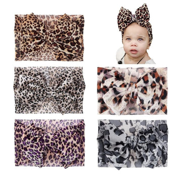 Baby girls' leopard print hair turban head wrap by Everything Baby, stretchy knotted bow headband for infants and toddlers.