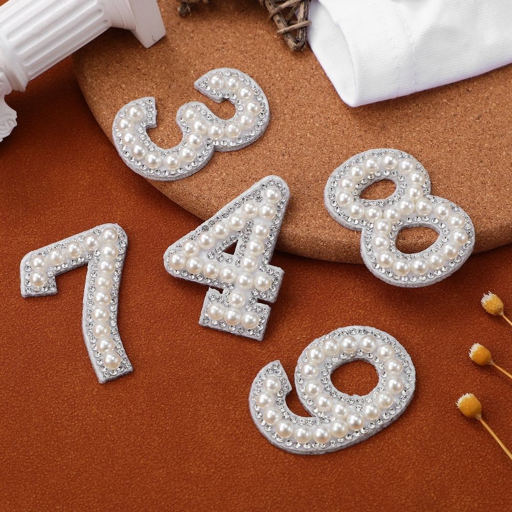 White rhinestone iron-on patches with wear-resistant numbers, designed for girls' shirts and hats by Everything Baby.