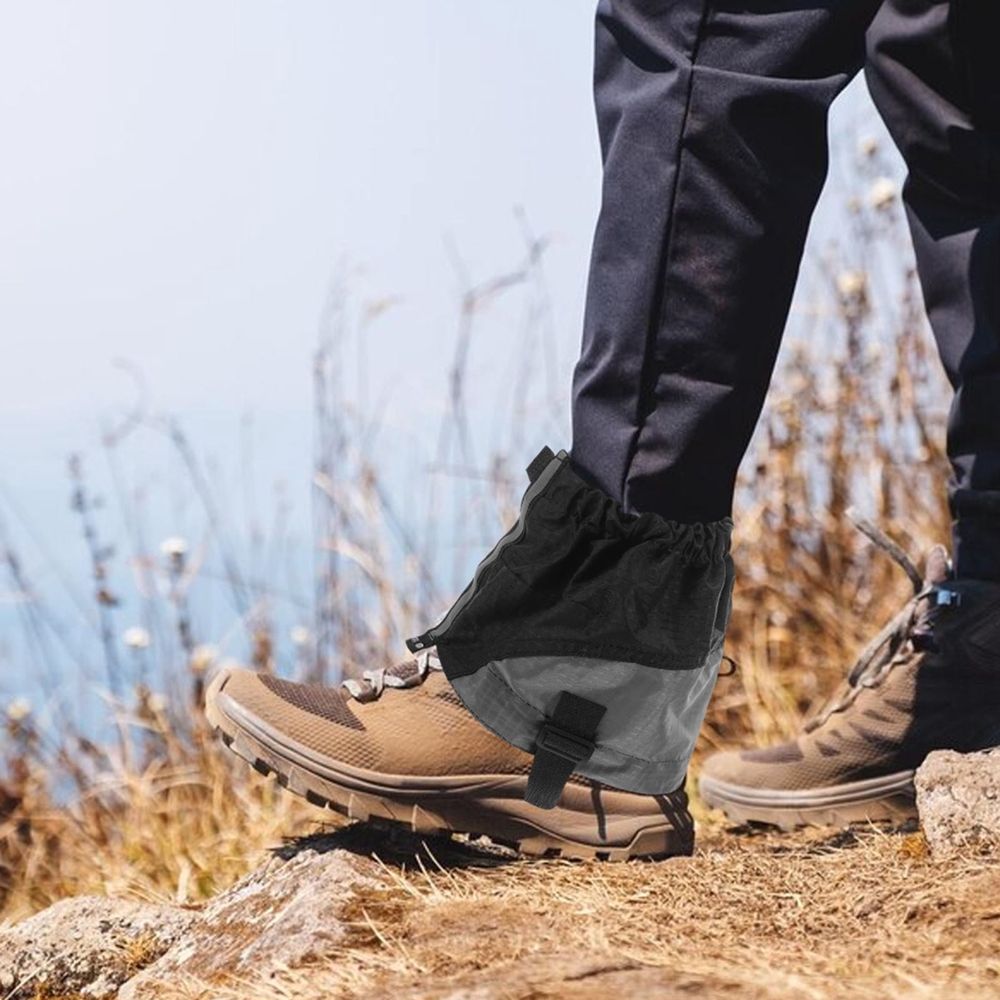 Pair of black lightweight hiking gaiters by Everything Baby, sandproof outdoor leg covers for camping, trail, hiking, and trekking.