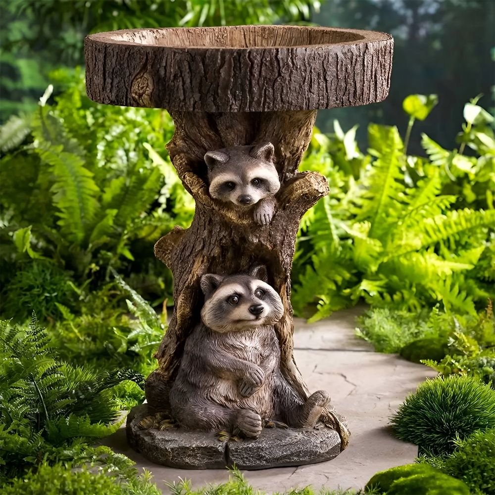 Resin raccoon birdbath for garden, antique-style polyresin bird bath with raccoon design in a home yard setting