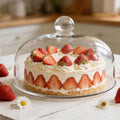Clear glass cake dome with knob, pastry display cover, heat-resistant food cover for kitchen and microwave use.
