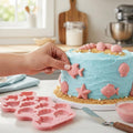 Two silicone molds featuring ocean animals, including shark and seashell designs, for baking, ice, or craft projects.